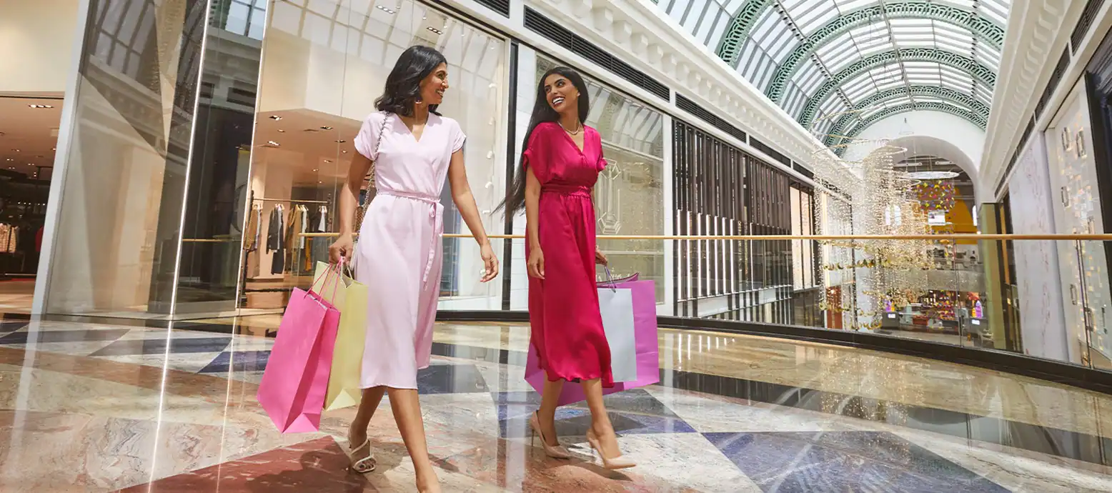 two women in shades of pink shopping at the dubai mall