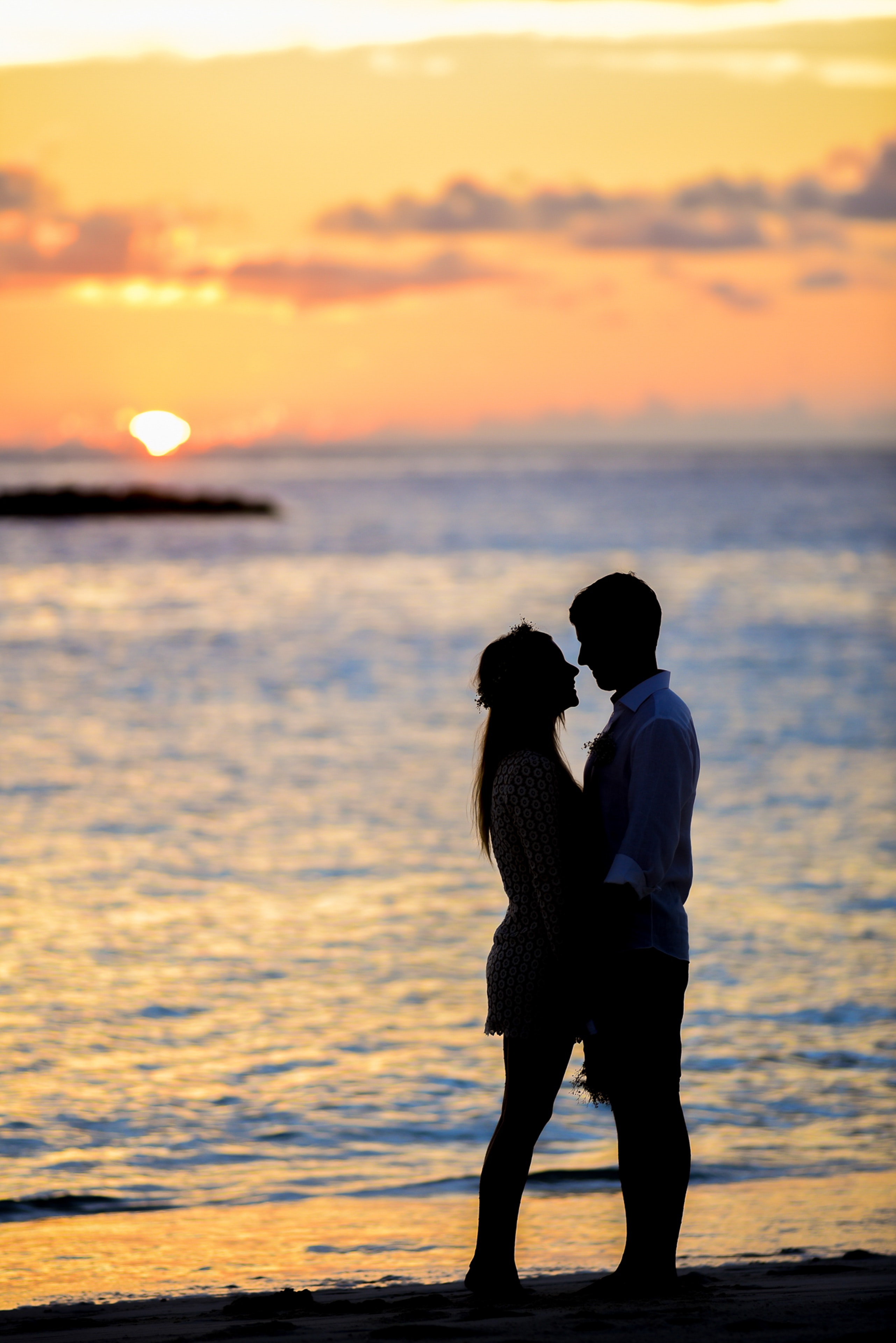 valentine's offer for maldives packages with couple silhouettes against the sunset