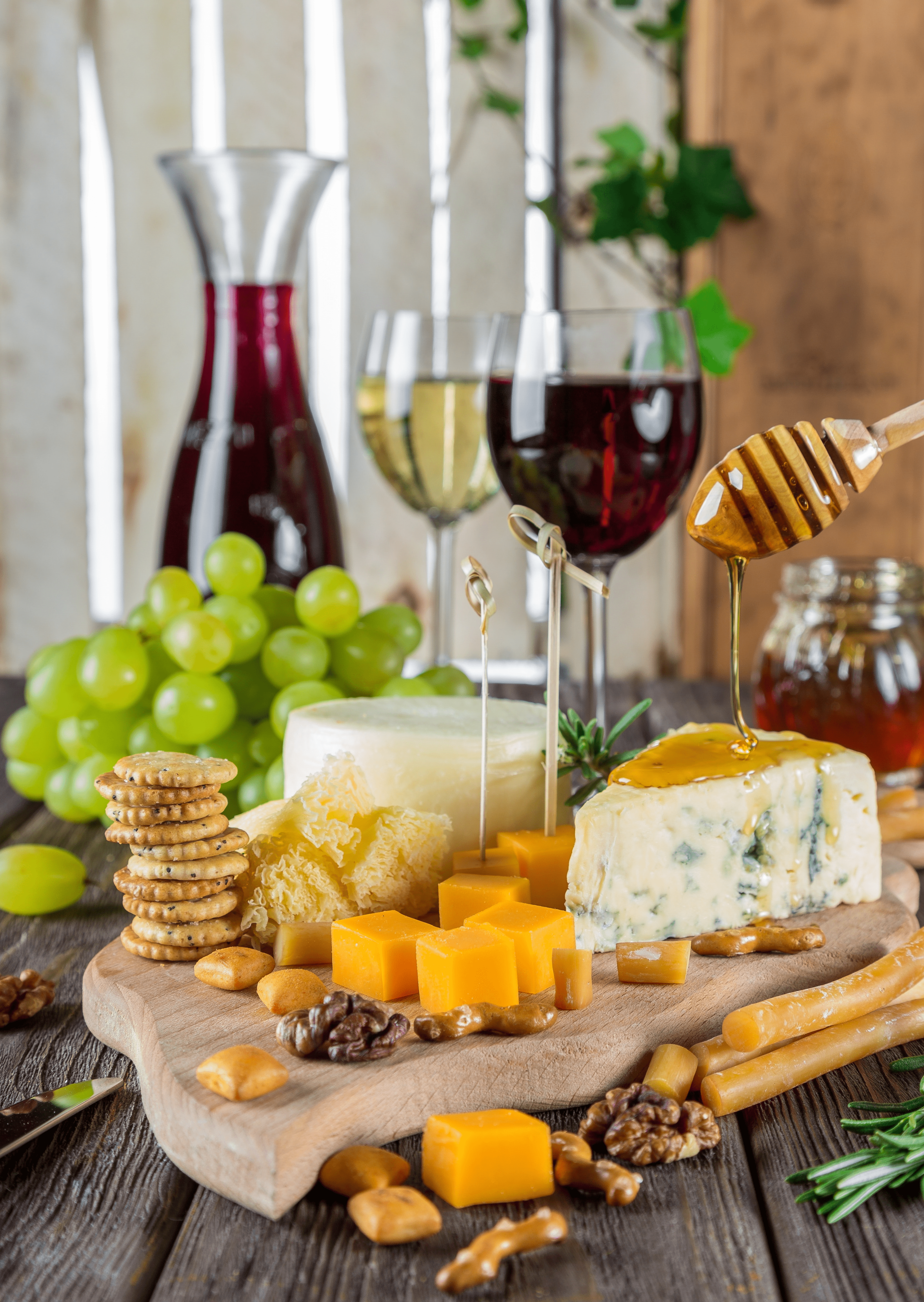 Wine and charcuterie board with different cheeses and biscuits