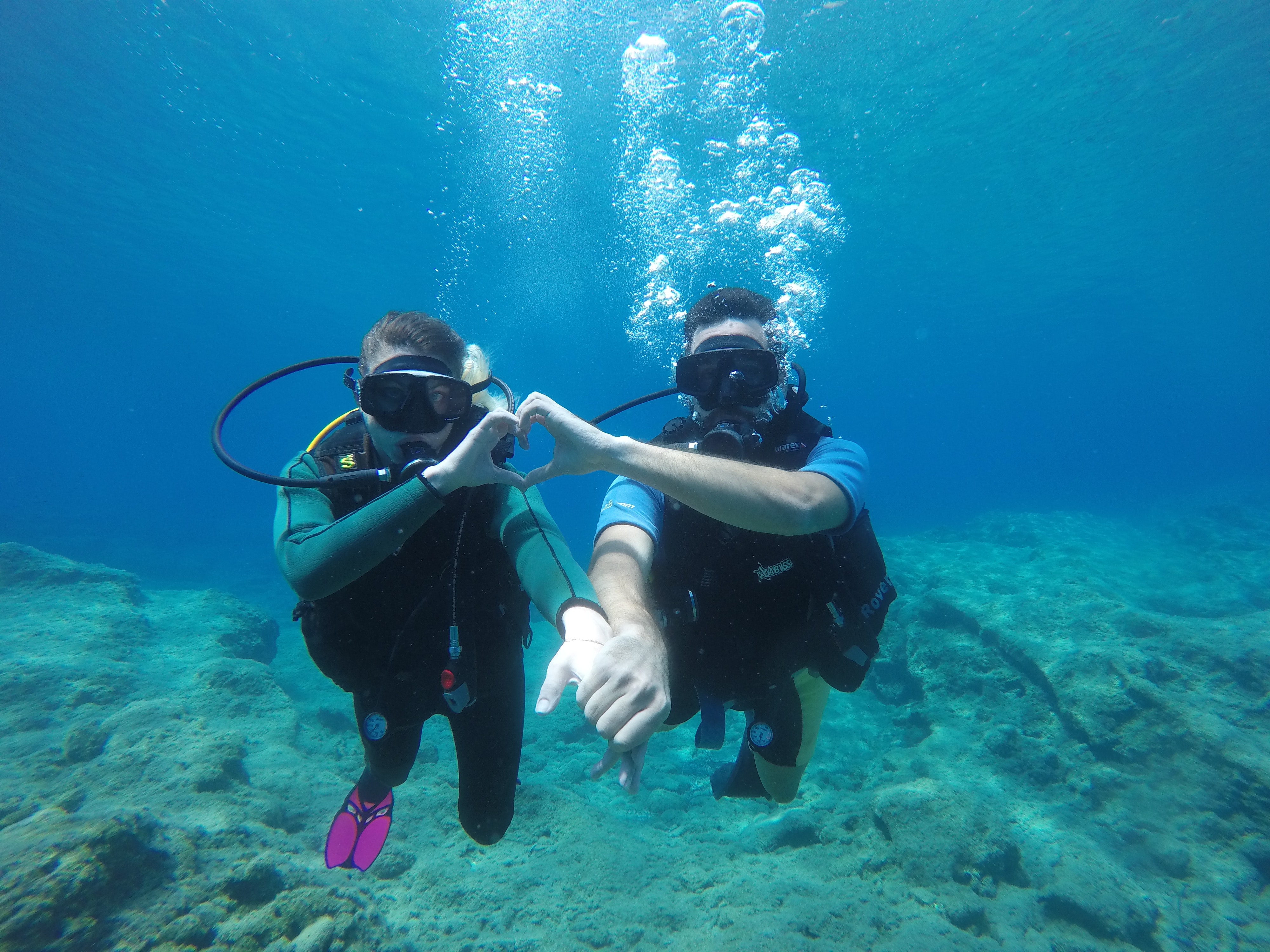 couple scuba diving in the maldives