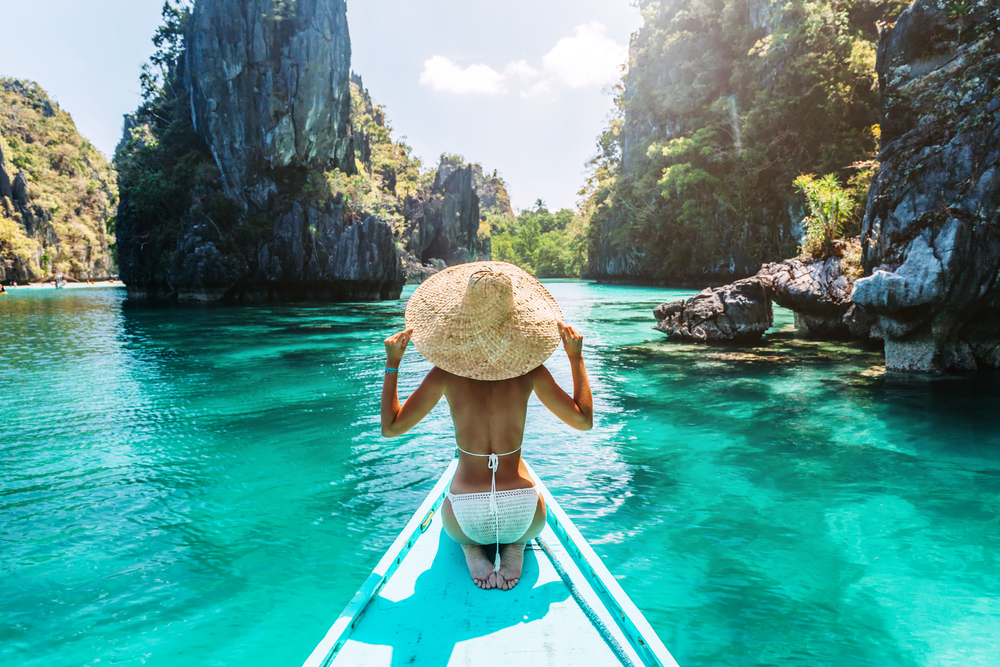 woman in bikini on a boat ride along the turquoise waters