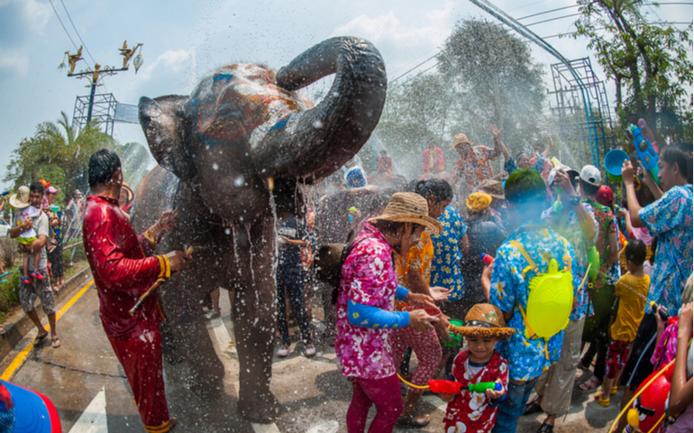 Thais, tourists and elephants join in water splashing during Songkran Festival in Ayutthaya, Thailand 
