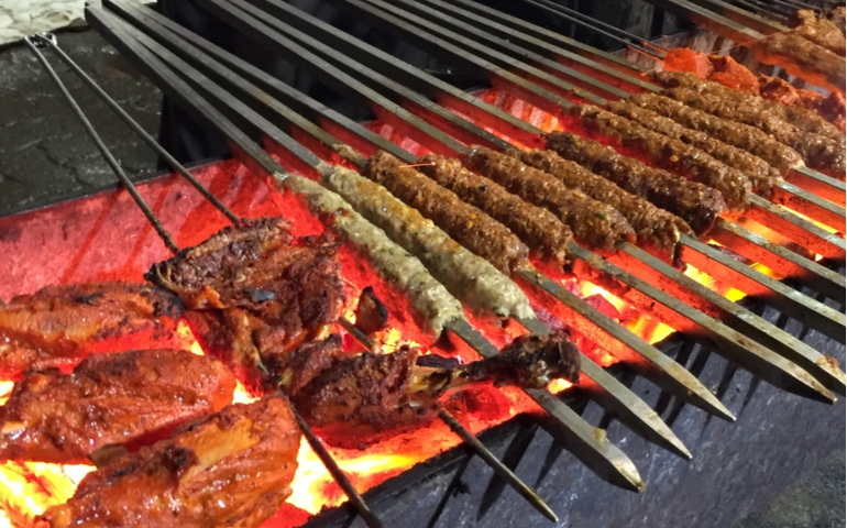 Seekh Kabab and Chicken Drumsticks being grilled at Mohammad Ali Road, Mumbai
