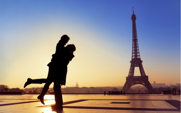 Silhouette of young couple in love with Eiffel Tower background in Paris, France
