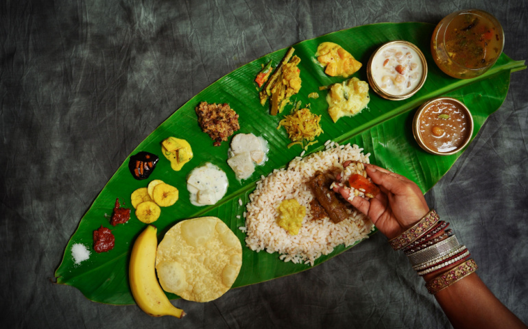 Eating Ona-Sadya in banana leaf during the festival of Onam