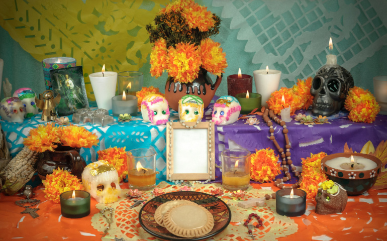 Traditional Day of the Dead Altar with sugar skulls and candles