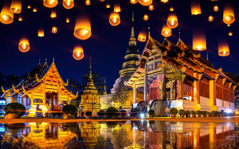 Sky lanterns at Wat Phra Singh temple at night in Chiang mai, Thailand