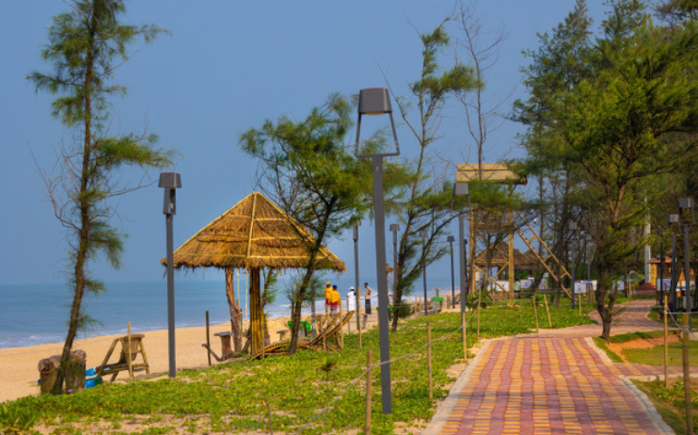 Umbrella huts with recliners are placed all along the shoreline at Kasarkod Beach for visitors.