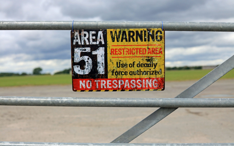 Vintage Area 51 Warning Sign Hanging On A Gate. Extraterrestrial Storage Facility Concept.
