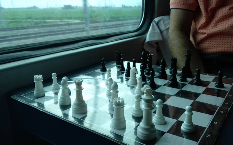 Passengers playing chess aboard a train in India 