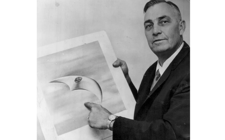 Kenneth Arnold, shown in 1966 with a drawing of a flying saucer, reportedly spent “many long hours of fruitless flying with a camera, trying and failing to find anything like his saucers again.” 