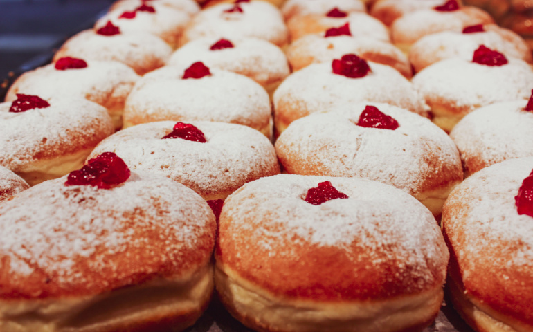 Fresh doughnuts with strawberry jam and powdered sugar