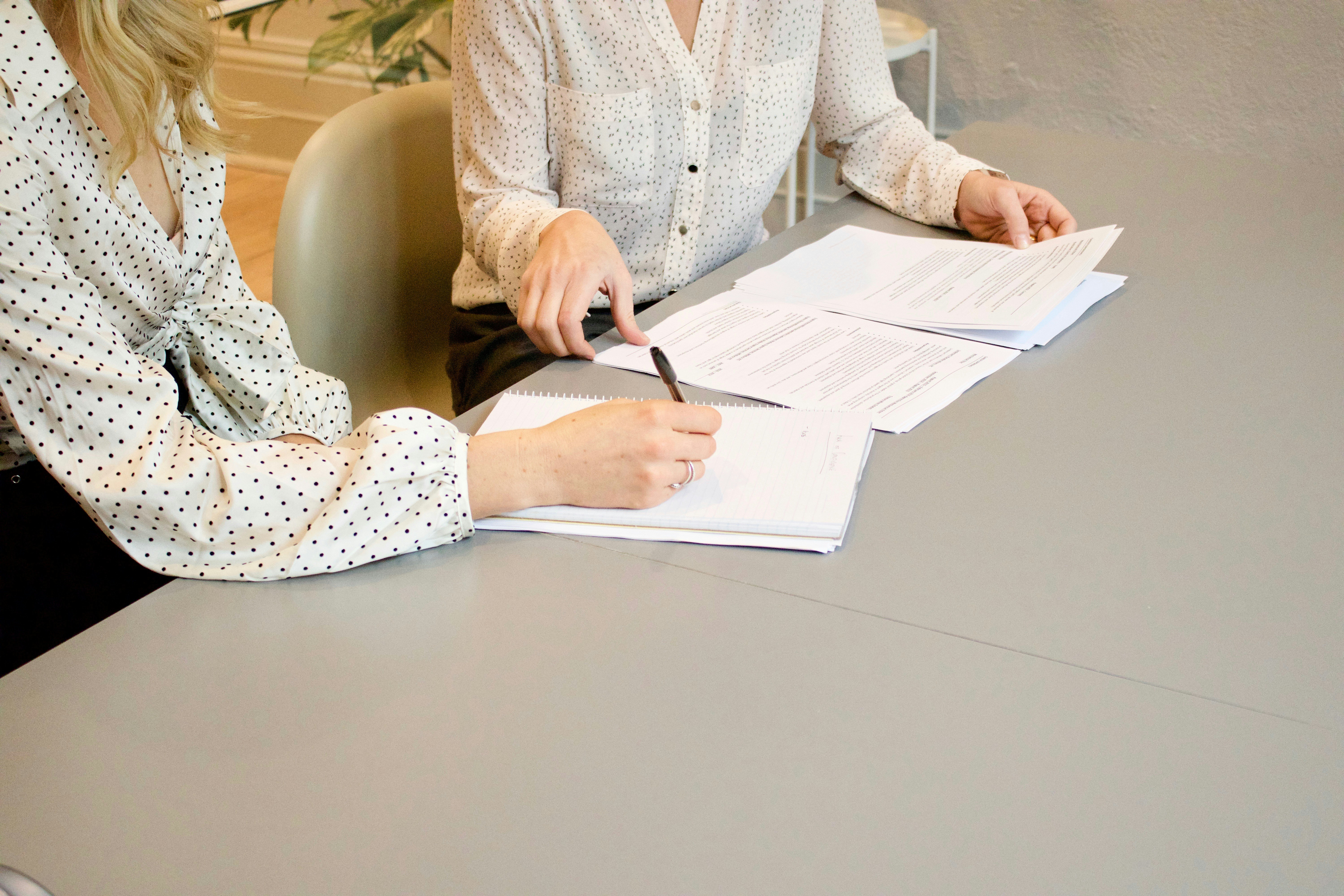 two girls signing documents