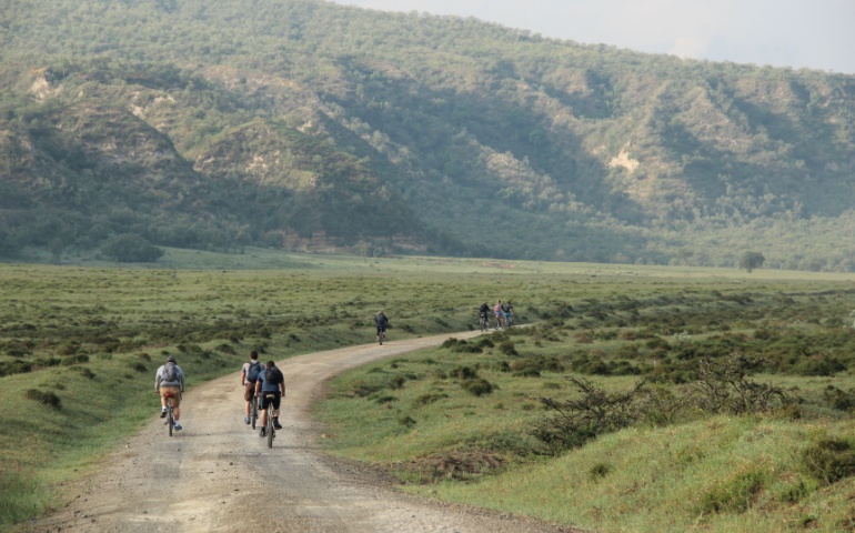 Cyclists ride bikes through Hell's Gate National Park in Kenya