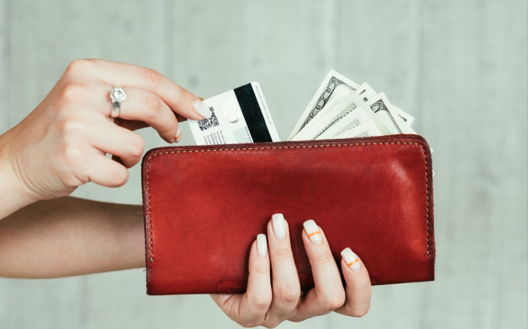 Girl removing card from her wallet. 