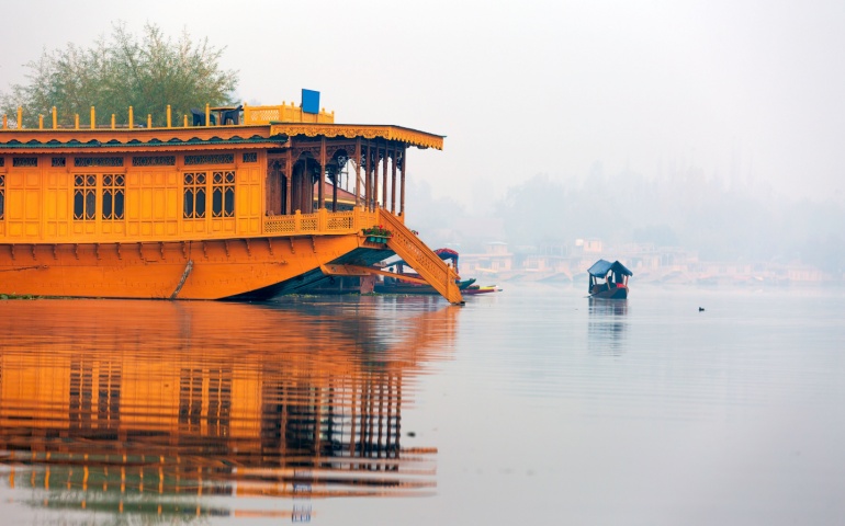 Side view of a houseboat in serene waters of Nigeen lake
