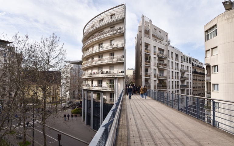 Coulée Verte René-Dumont Walkway Bridge Splitting Apartment Buildings in 12th Arrondissement, Paris, France.
