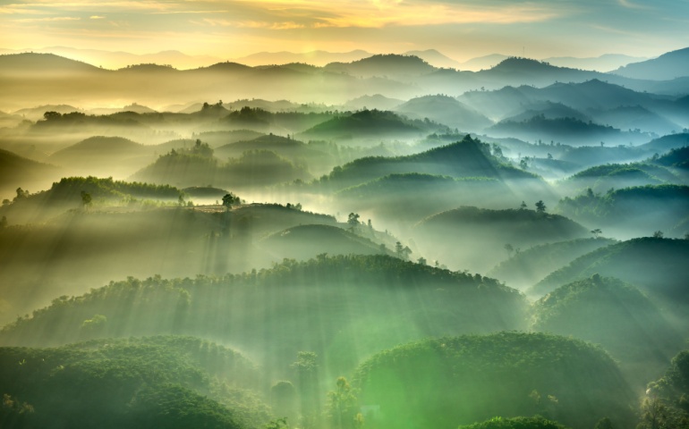 Fanciful scenery of an early morning when the sun rises over the Dai Lao mountain range, Bao Loc district, Lam Dong province, Vietnam.
