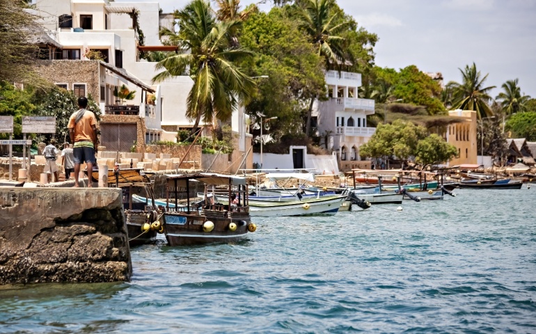 Local fishermen and fishing boats in Lamu Island, Kenya.
