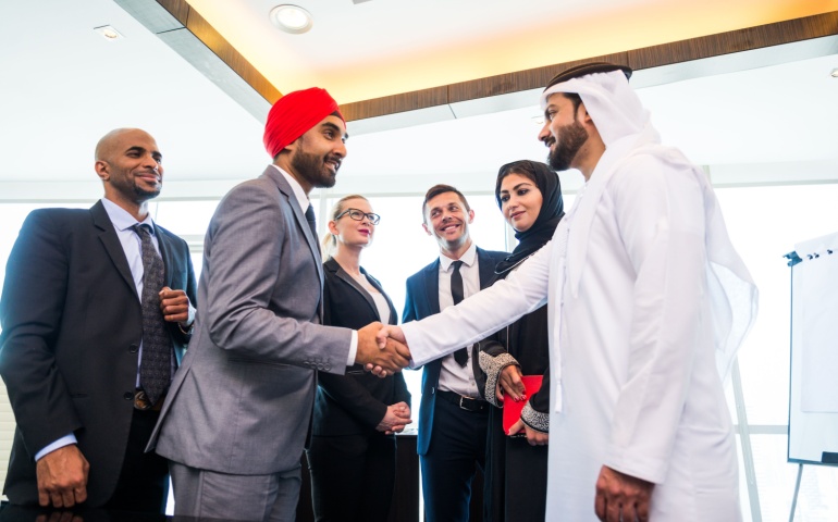 A group of people shaking hands and talking