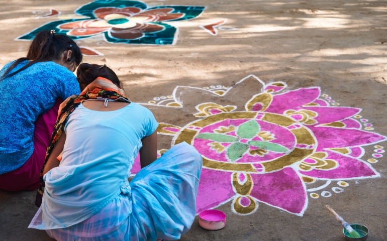 Women making rangoli in preparation for Diwali.