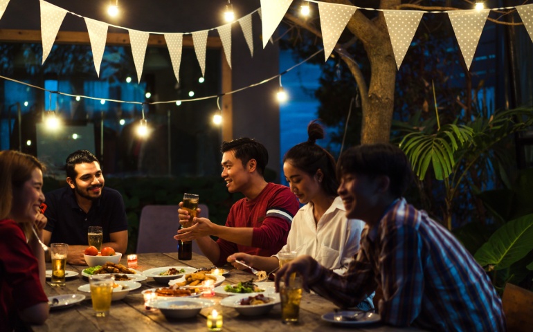 A friend group bonding over a meal with drinks