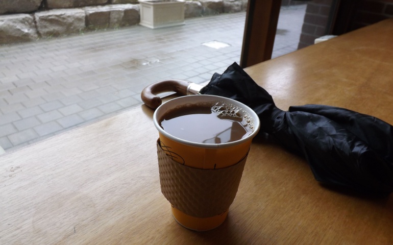 Umbrella and coffee cup on a table