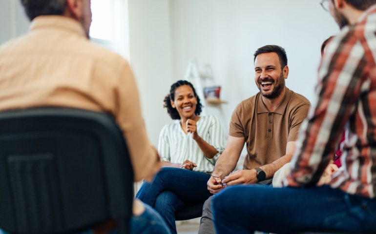 A group of people talking and laughing.