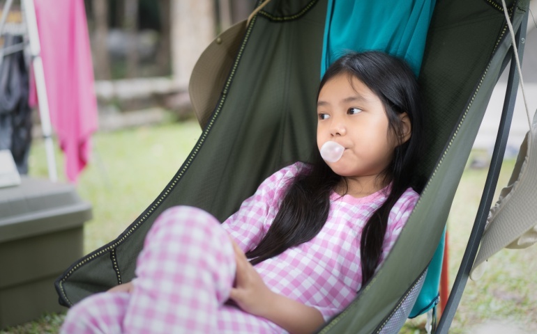 A young girl chewing gum