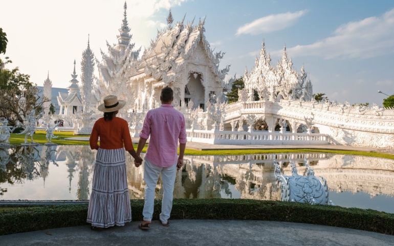 Couple visiting the White Temple in Thailand