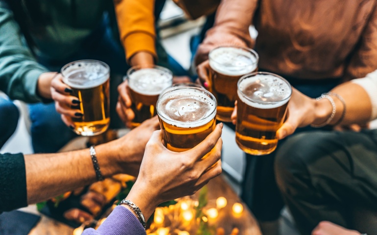 A group of friends clinking glasses of beer