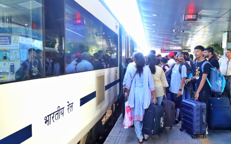 Passengers boarding the Vande Bharat with luggage