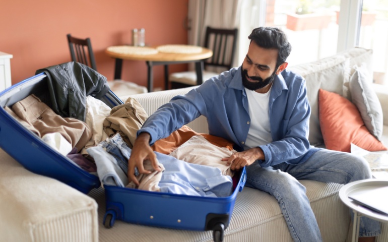 Man packing suitcase