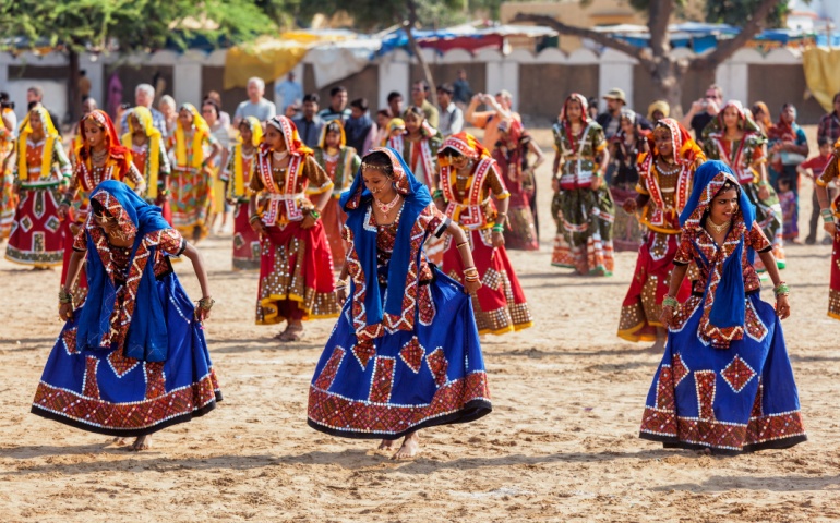 Women dancing in traditional attire at Pushkar Mela