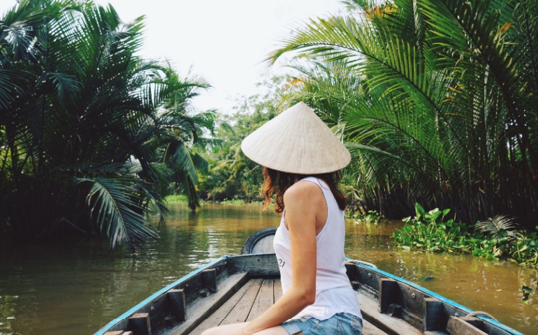 A woman riding a boat in the Mekong River