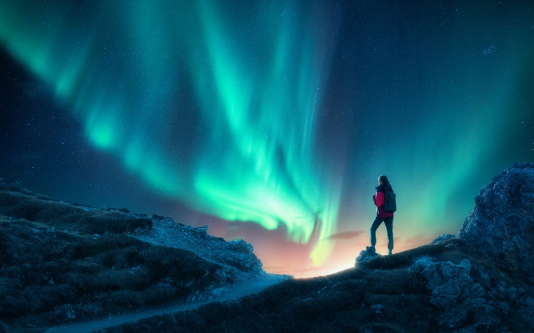 Woman watching the Aurora Borealis in Iceland