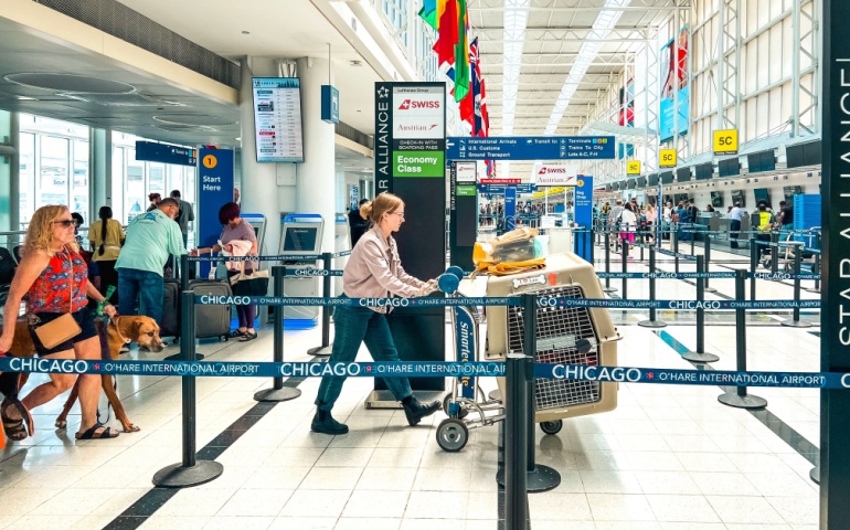 Two women are travelling with a dog at Chicago