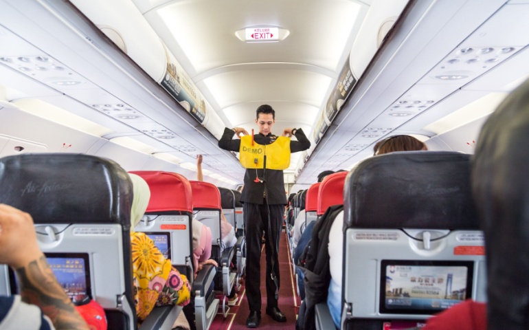 Flight Attendant Demonstrating Safety Procedure