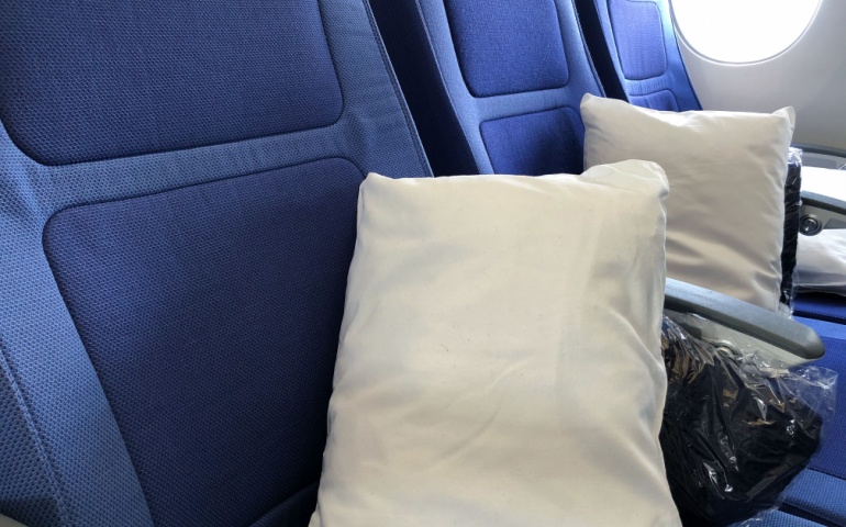 Pillows and blankets on blue Economy Class