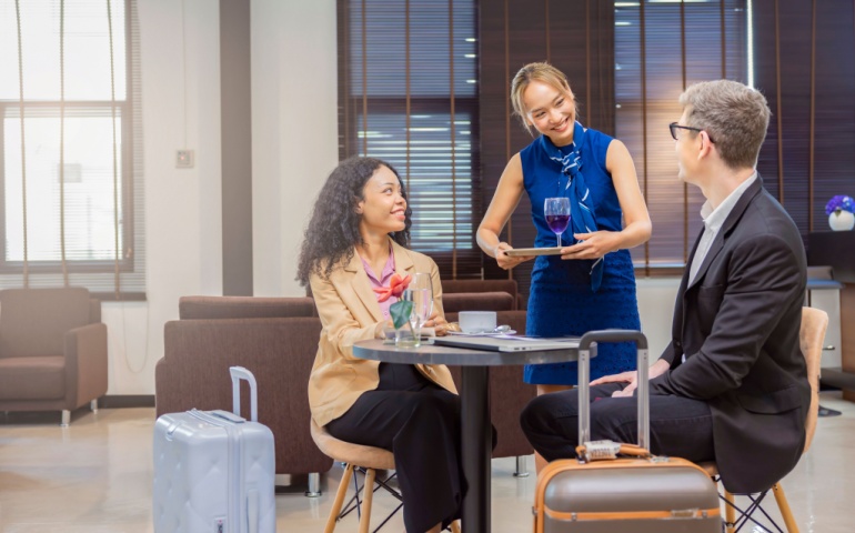 Discussing Business and Using Laptop at Airport Lounge