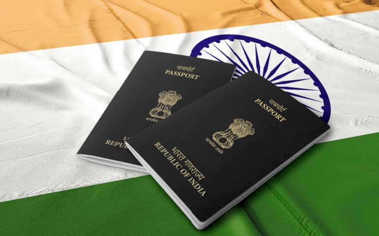 Indian Passport with the Indian flag in the background