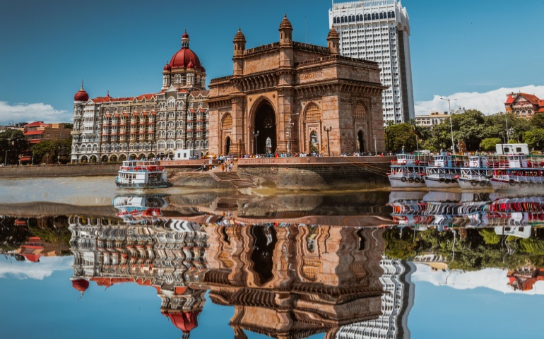 The Gateway of India reflected on the water surface.