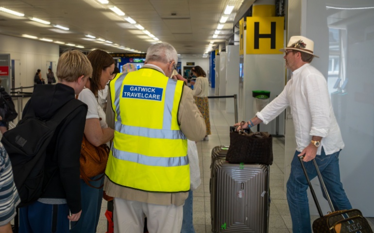 A Volunteer with Gatwick Travel Care Assists Travelers